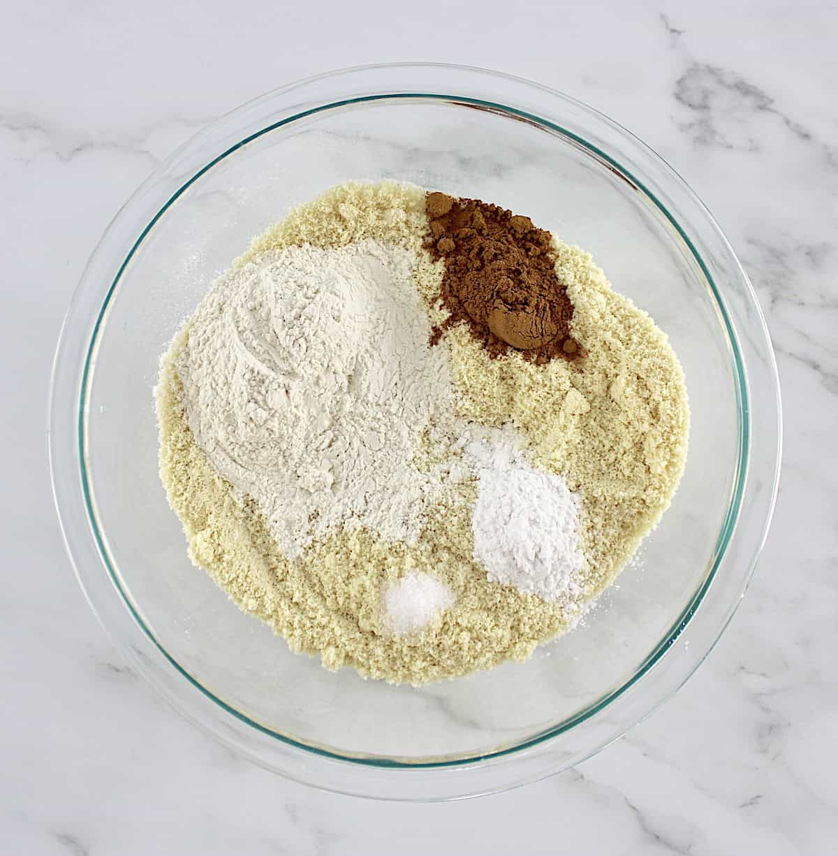 dry ingredients for Pumpkin Spice Cake in glass bowl unmixed