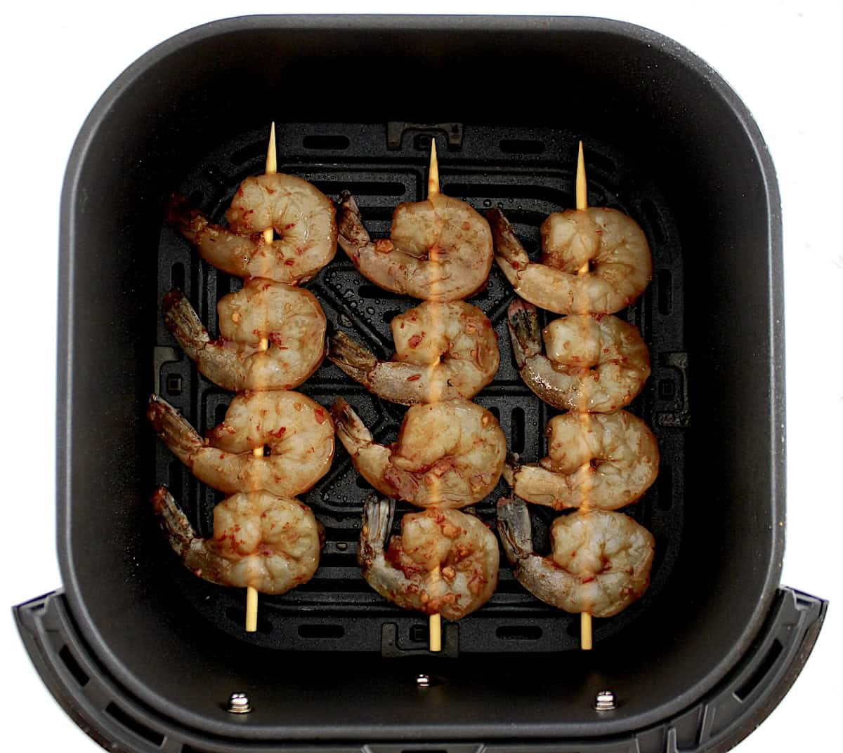 raw Asian Shrimp Skewers in air fryer basket