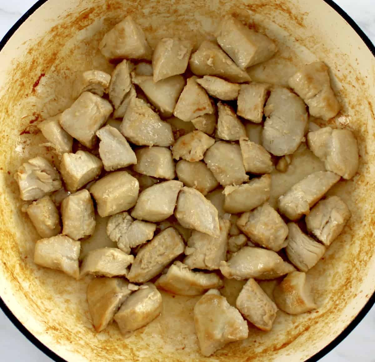 cooked bites of chicken in skillet