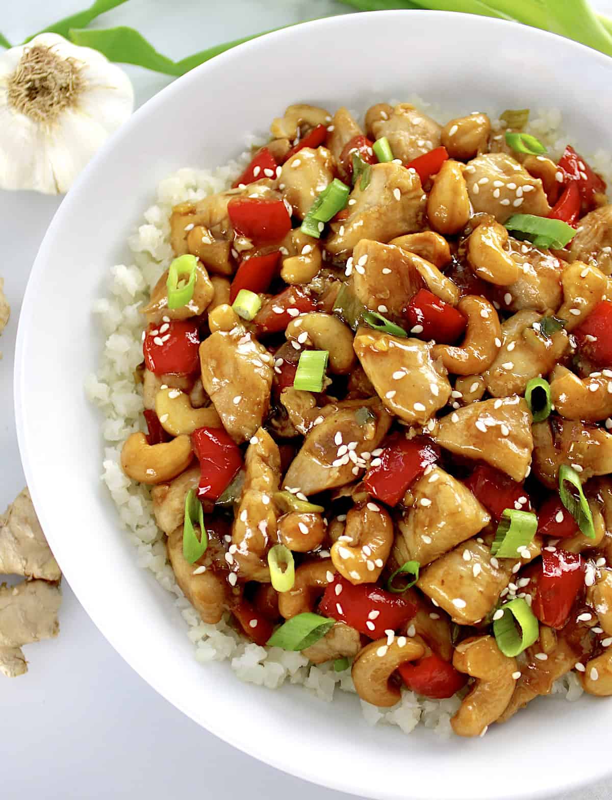 Cashew Chicken in white bowl over cauliflower rice