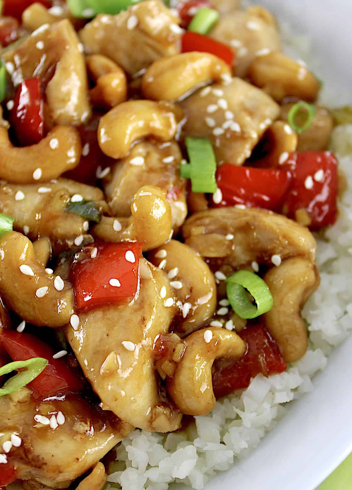 closeup of Cashew Chicken in white bowl with cauliflower rice