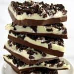 Cookies and Cream Bark pieces stacked up on white plate