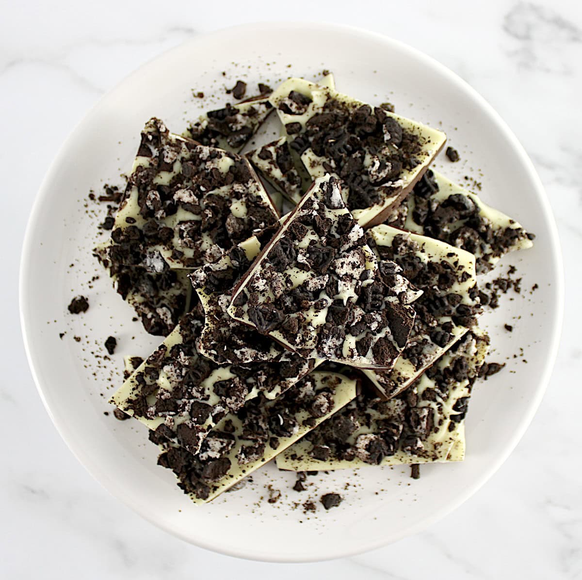 overhead view of pieces of Cookies and Cream Bark on white round plate