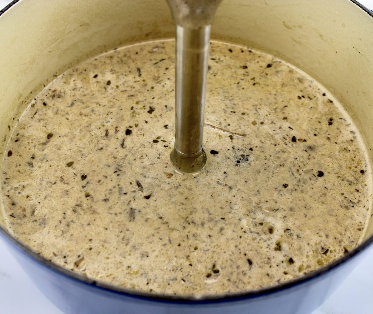 Cream of Wild Mushroom Soup in dutch oven with immersion blender