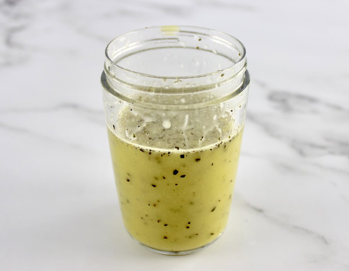 Greek Zucchini Pasta Salad dressing in salad dressing shaker