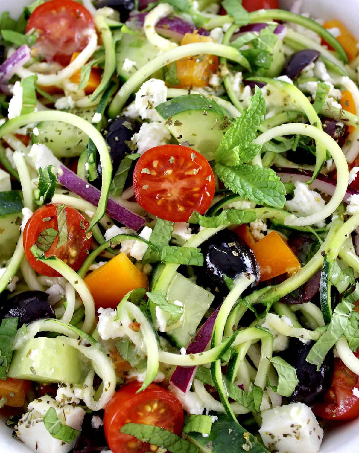 closeup of Greek Zucchini Pasta Salad with chopped mint on top