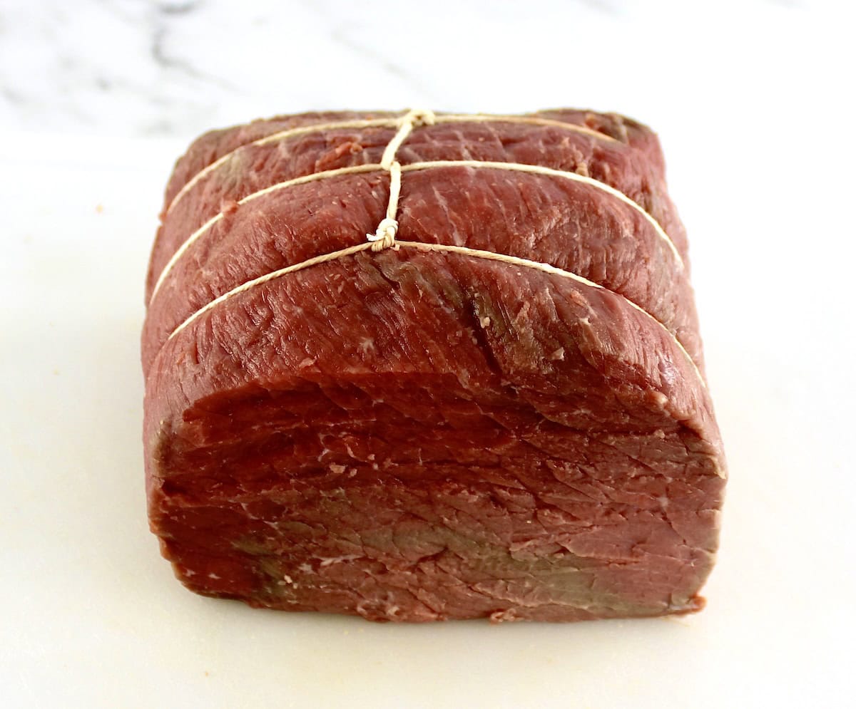 raw roast beef tied with kitchen twine