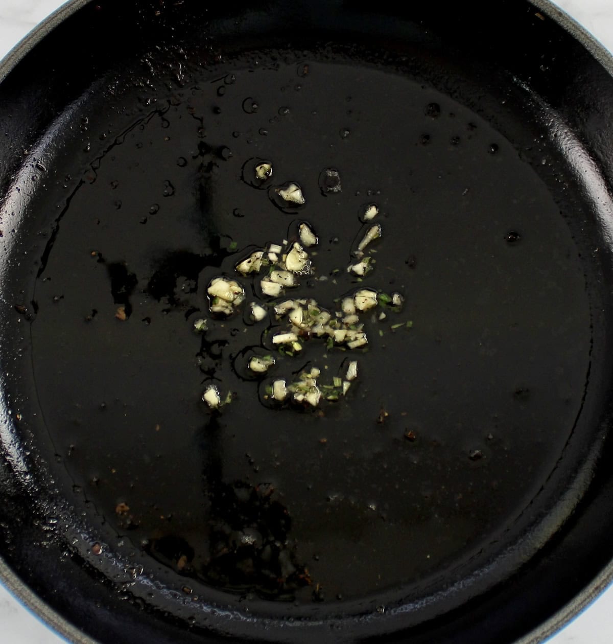 roast pan drippings with minced garlic in skillet