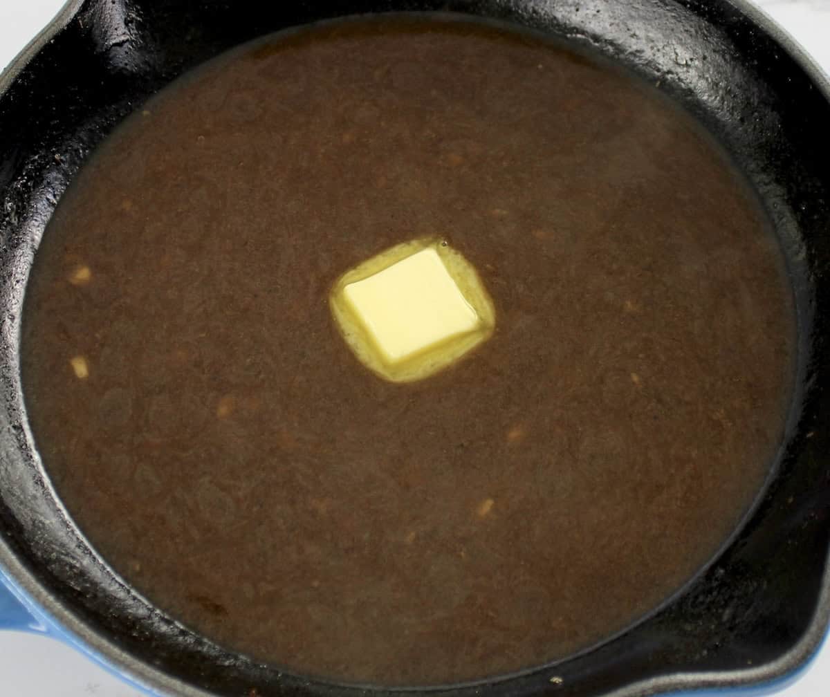 Roast Beef gravy with pad of butter in center of skillet