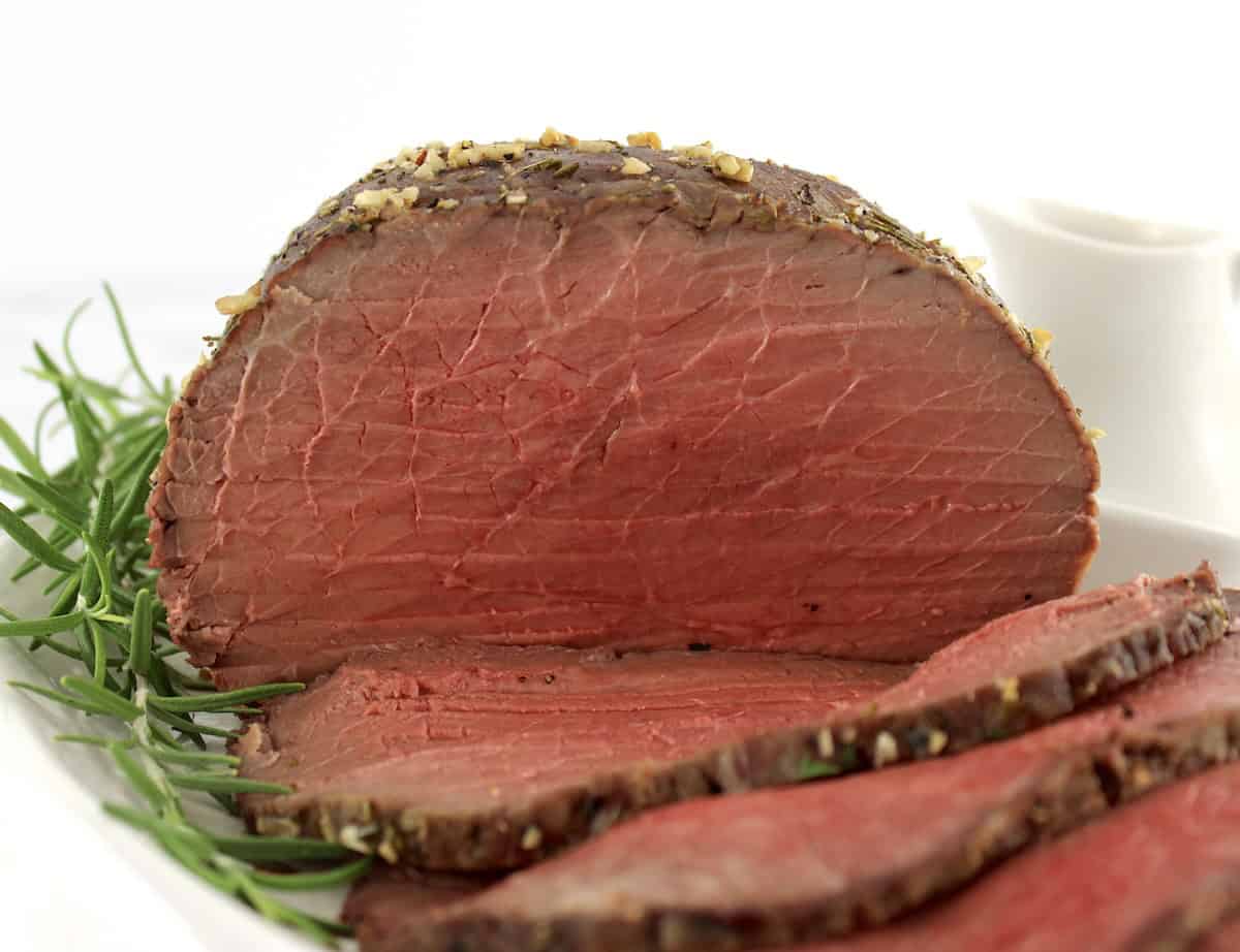 roast beef with slices on white plate