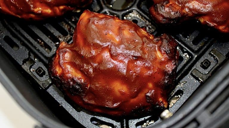 closeup of Air Fryer BBQ Chicken Thigh in air fryer basket