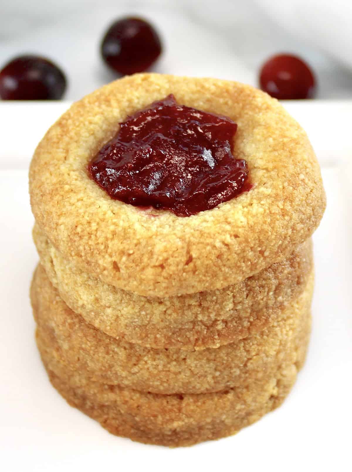 Cranberry Thumbprint Cookies stacked up on each other