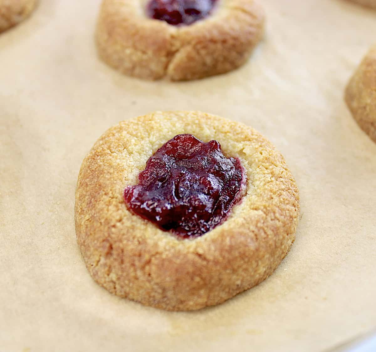 Cranberry Thumbprint Cookies on parchment paper