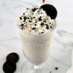 Keto Cookies and Cream Milkshake with oreo on top with whip cream and cookie crumbs