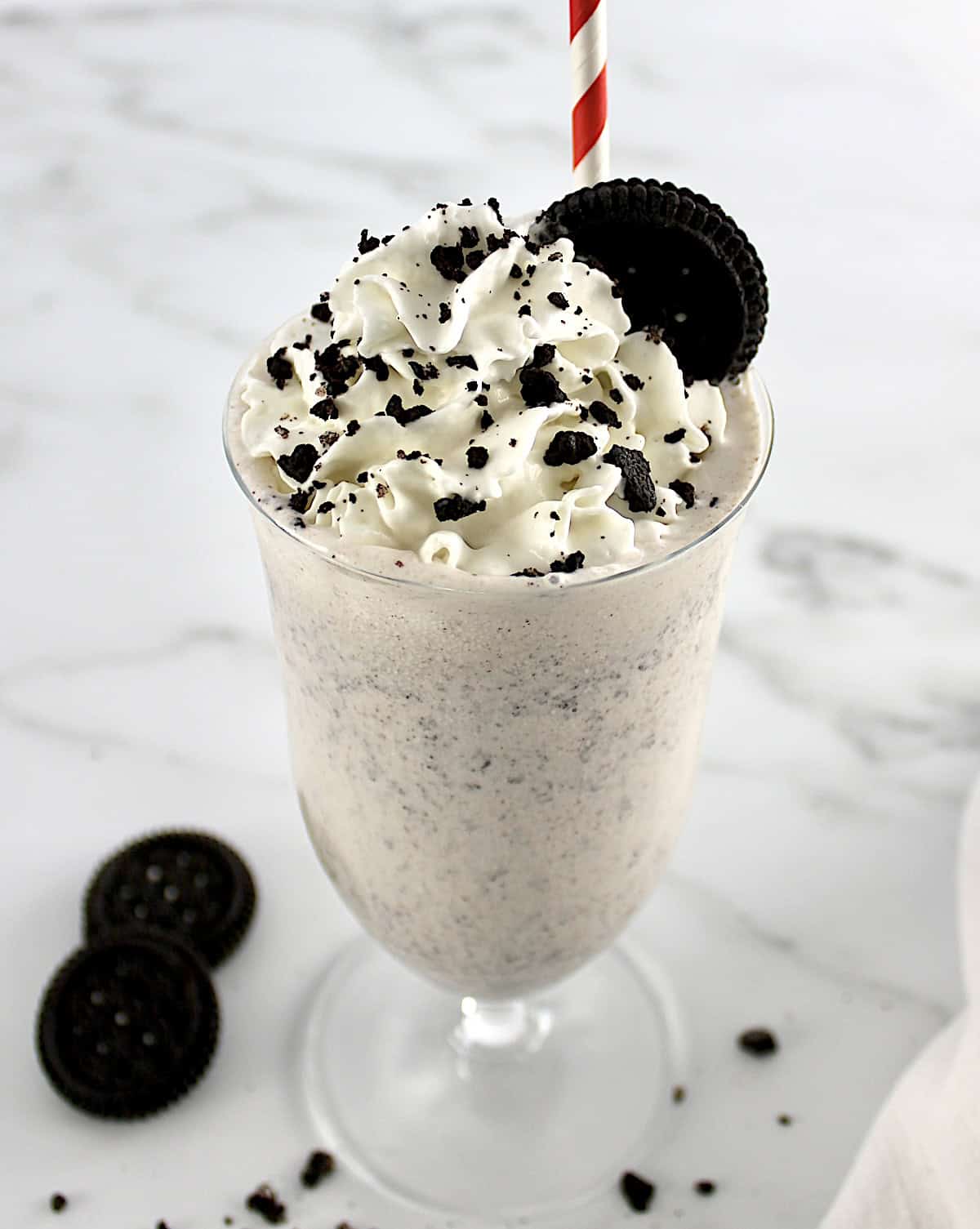 Keto Cookies and Cream Milkshake with oreo on top with whip cream and cookie crumbs