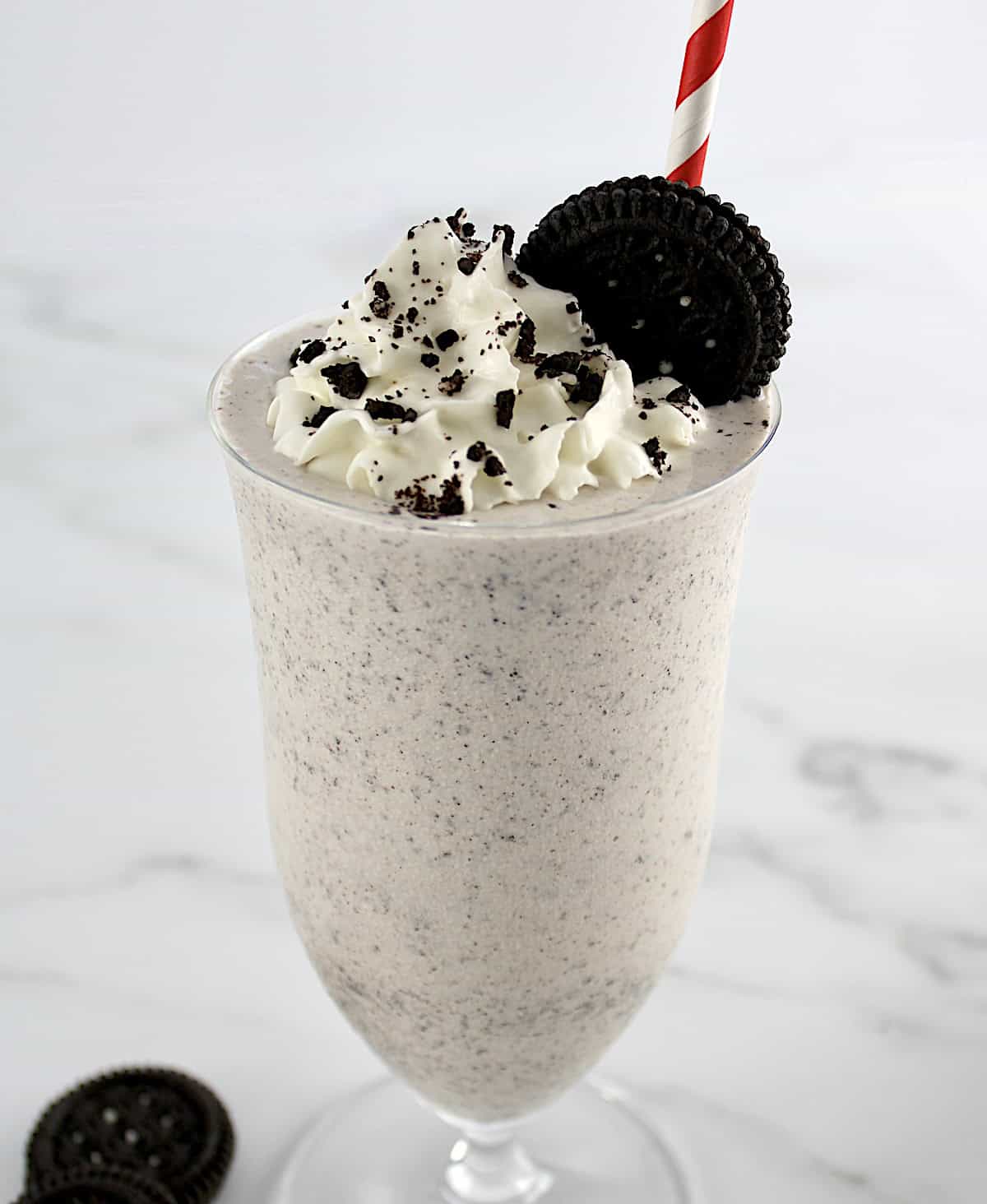 Keto Cookies and Cream Milkshake with oreo on top with whip cream and cookie crumbs