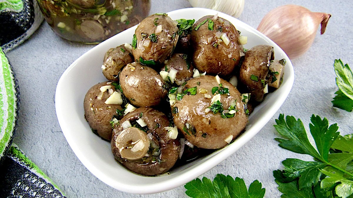 white bowl with marinated mushrooms, garlic