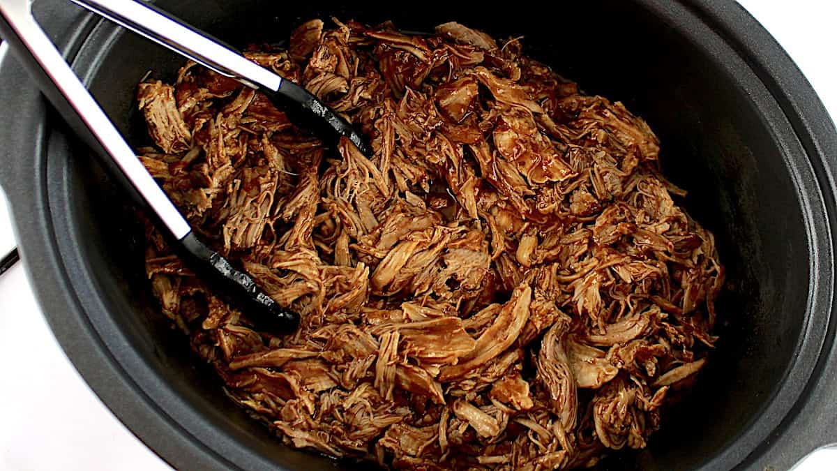 Slow Cooker Pulled Pork with tongs