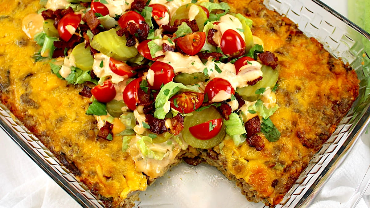 Bacon Cheeseburger Casserole with lettuce, tomatoes and pickles on top