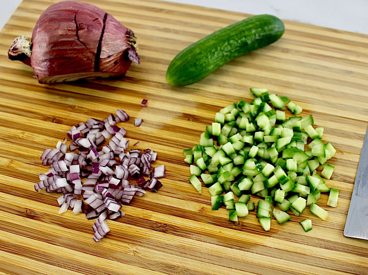 diced cucumber and red onion on cutting board