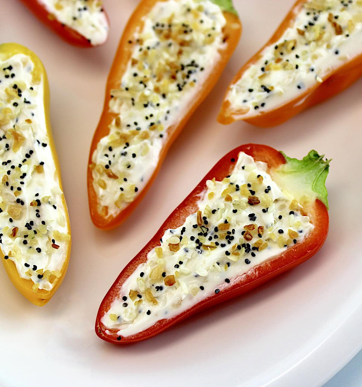 closeup of Everything Bagel Stuffed Mini Peppers on white plate