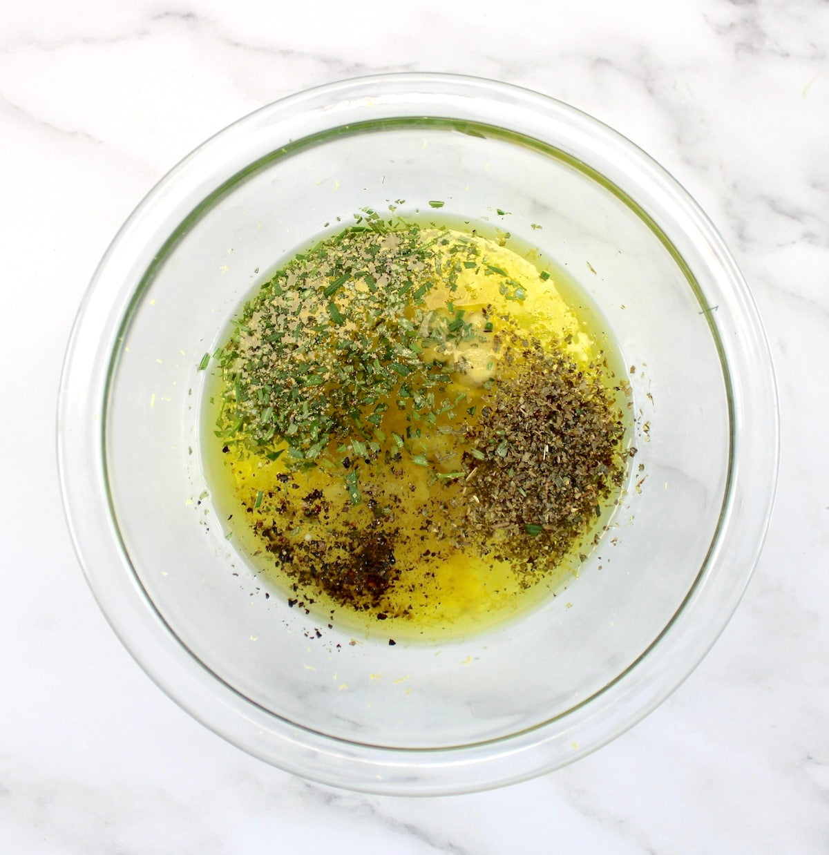  Greek Lemon Chicken marinade ingredients in glass bowl unmixed