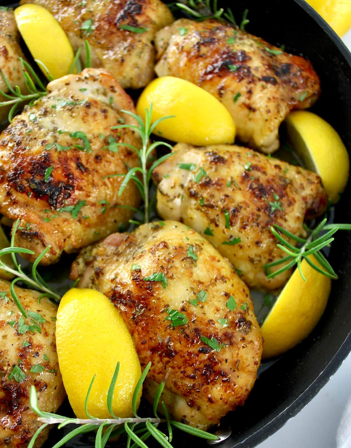 closeup of Greek Lemon Chicken with lemon and rosemary