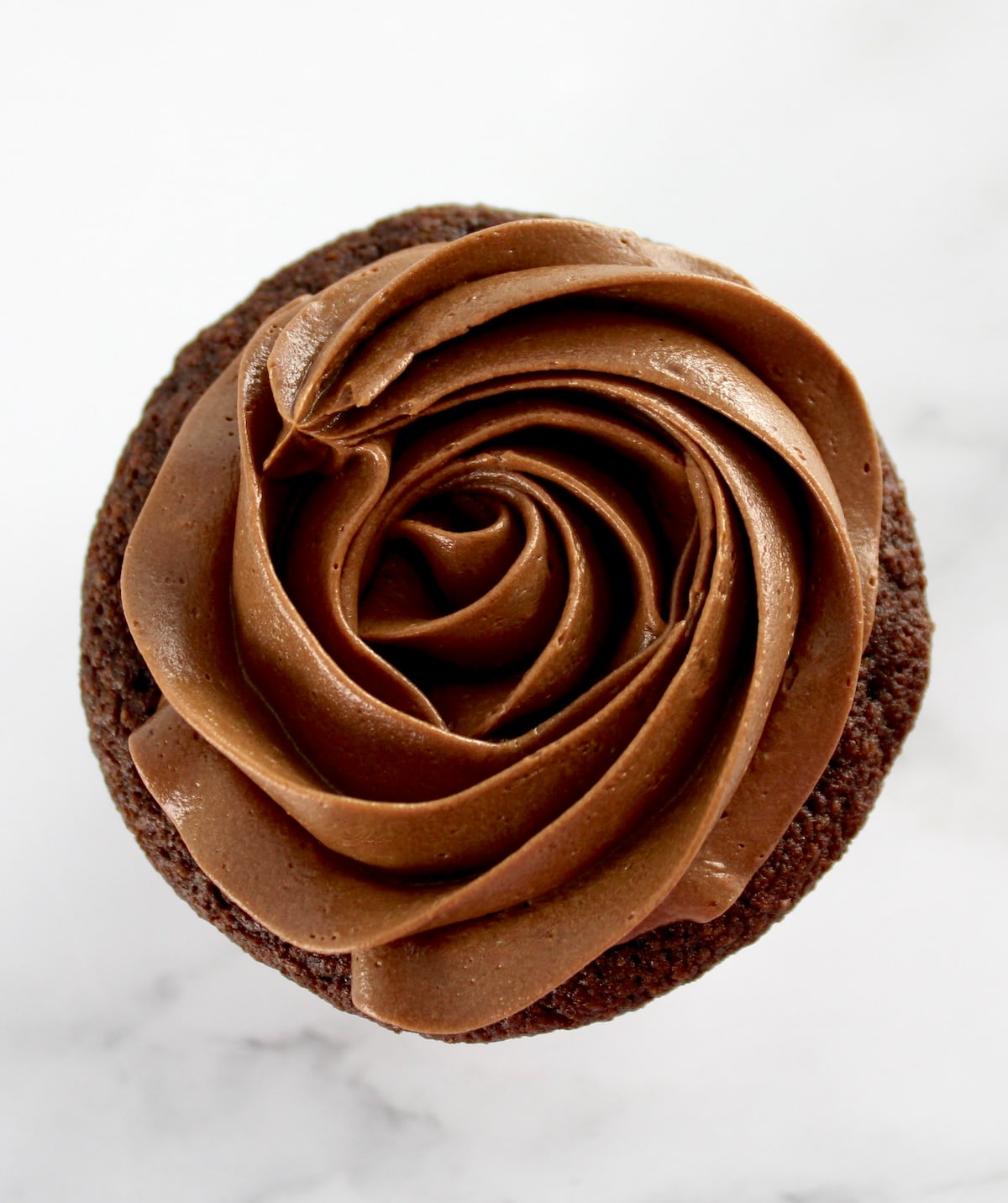 overhead view of Keto Chocolate Frosting in rosette on cupcake