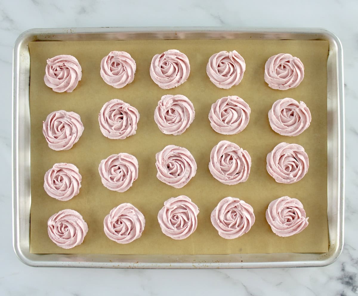 20 Keto Strawberry Meringue Cookies unbaked on baking sheet with parchment paper