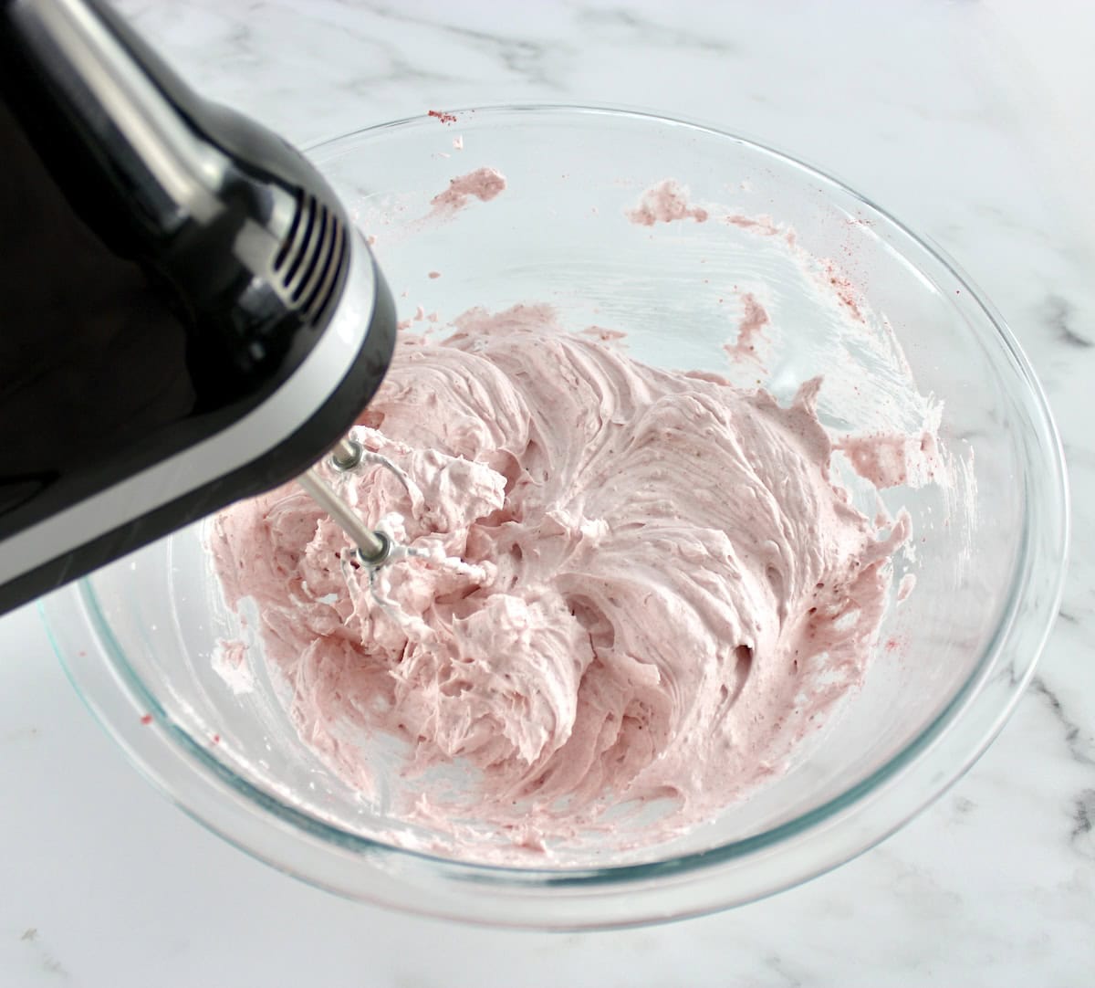 Keto Strawberry Meringue Cookies batter in glass bowl with hand mixer