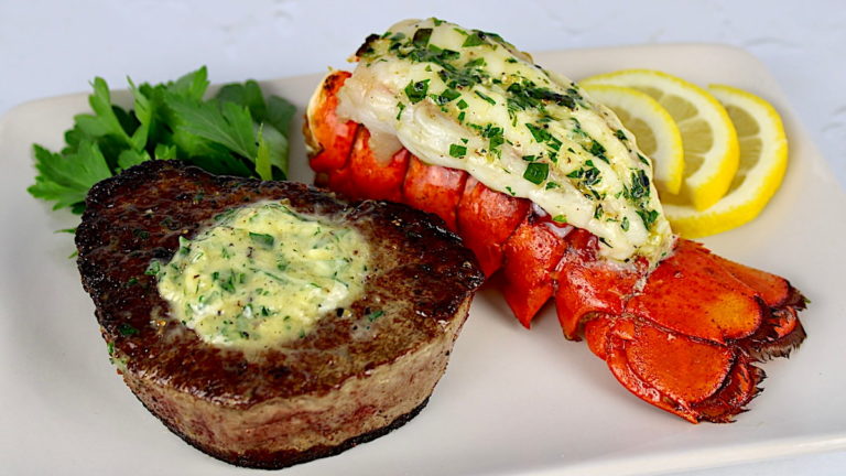 filet mignon with herb butter on top and lobster tail on side