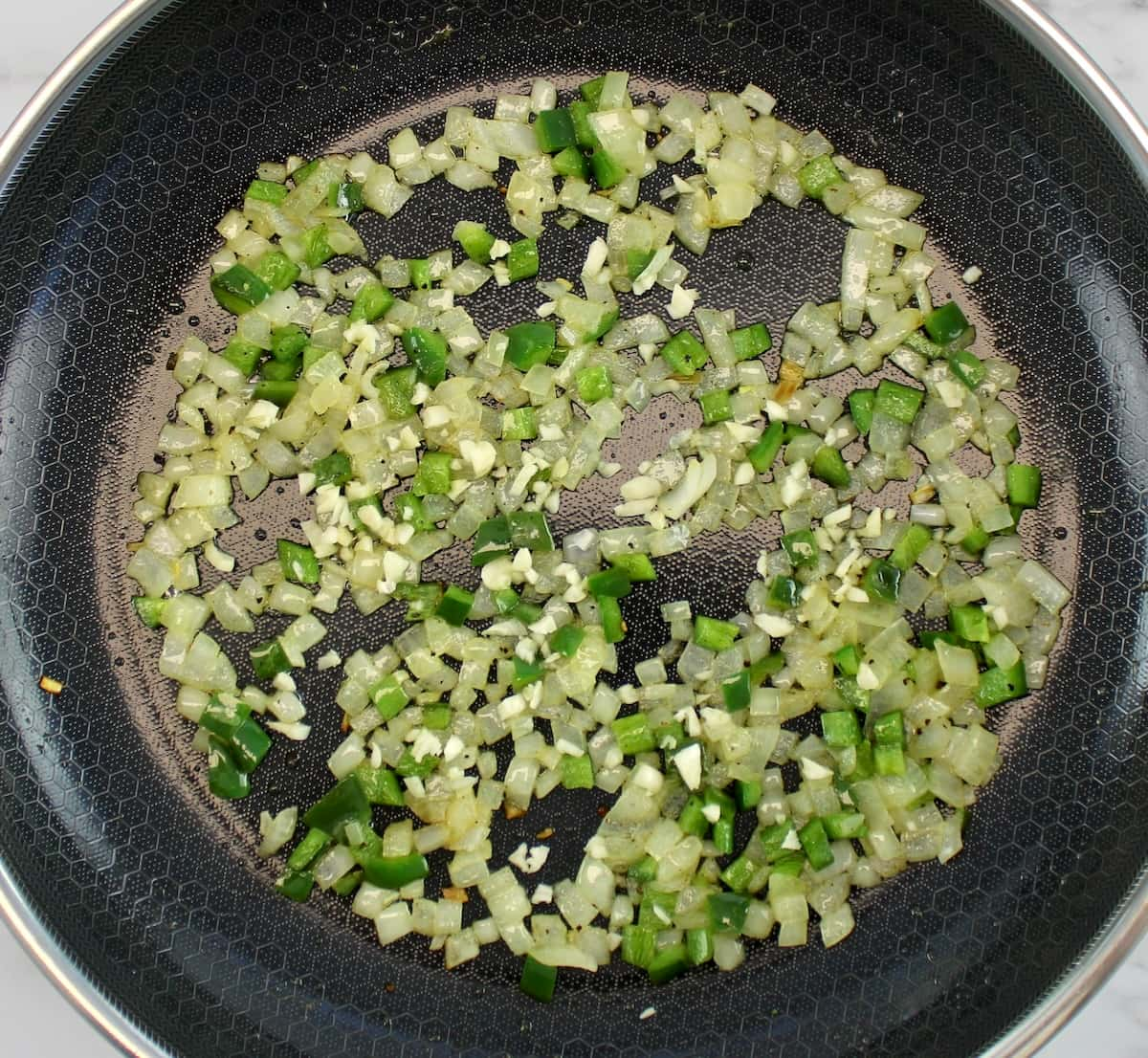 diced onions, garlic and jalapeño peppers in skillet