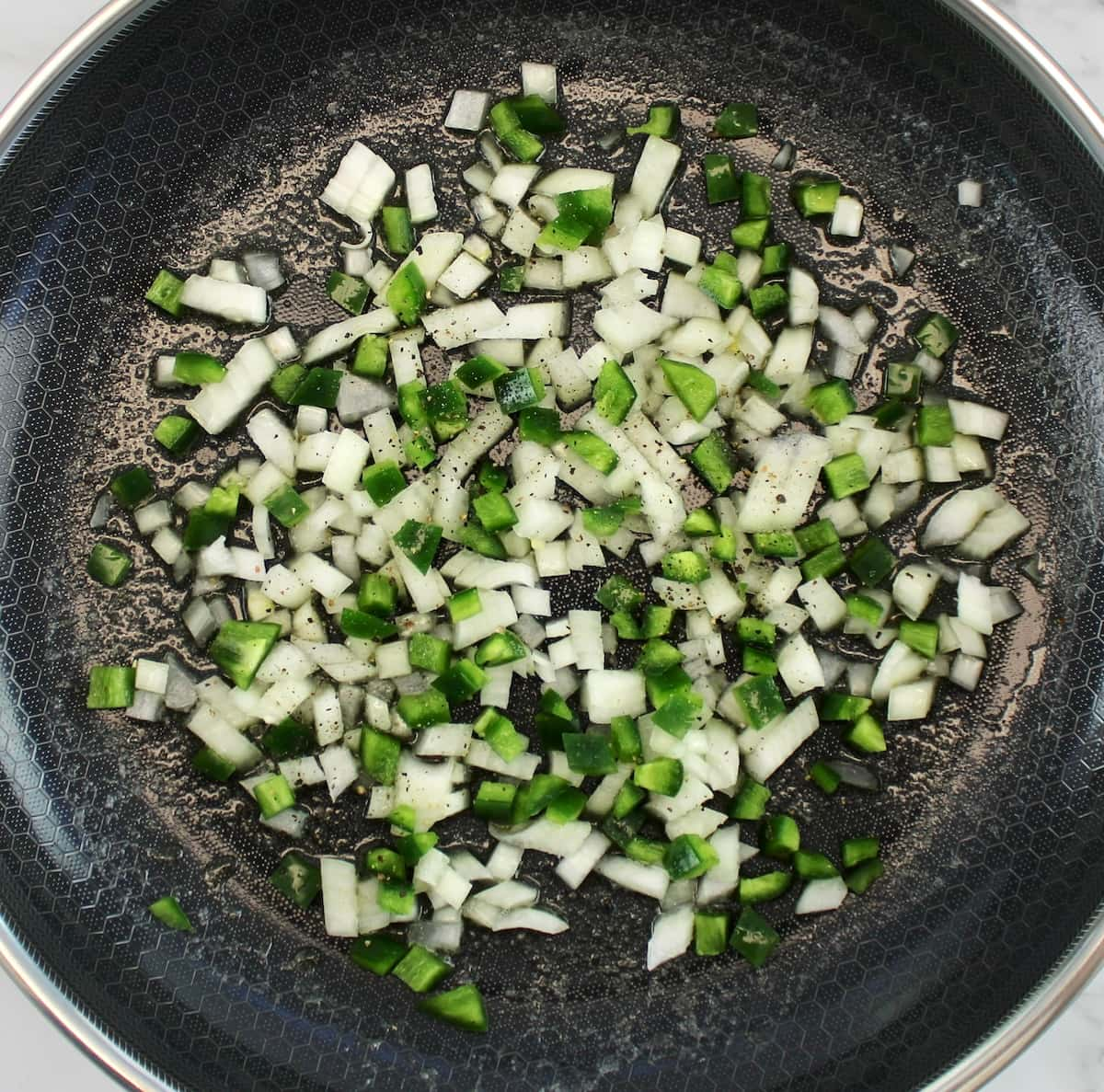 diced onions and jalapeño peppers in skillet