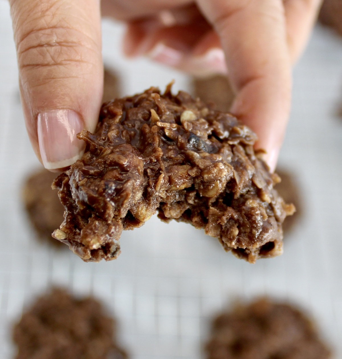 holding up No-Bake Keto Cookie with bite taken out