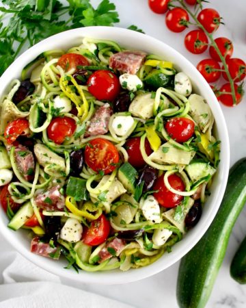 Zucchini Noodle Pasta Salad in white bowl with veggies all around