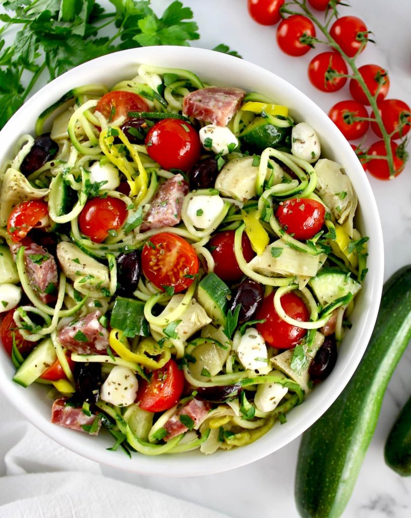 Zucchini Noodle Pasta Salad in white bowl with veggies all around