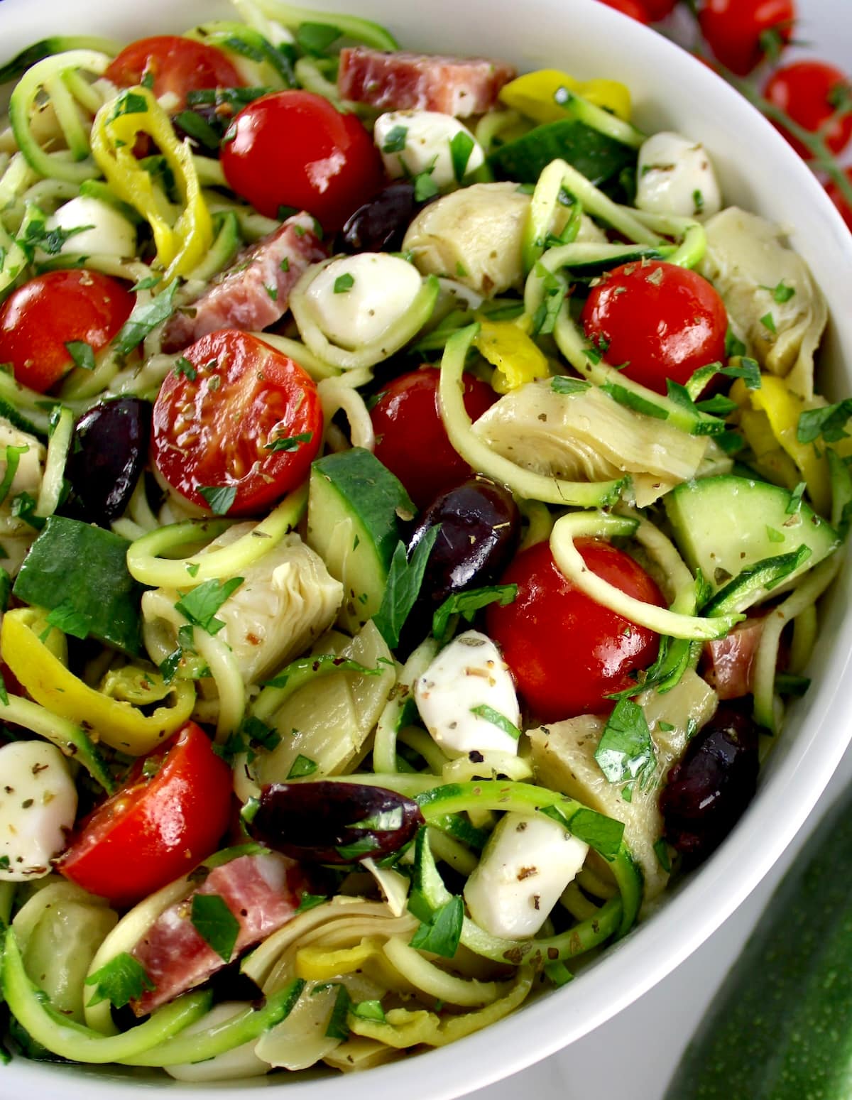 closeup of Zucchini Noodle Pasta Salad in white bowl