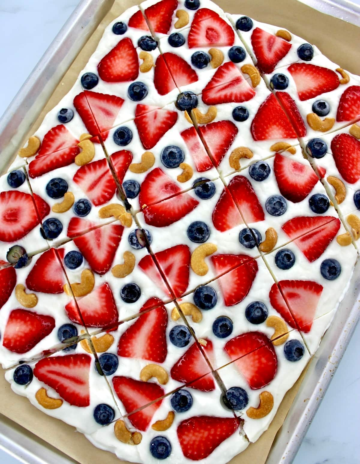 Frozen Yogurt Berry Bark on parchment paper cut into pieces