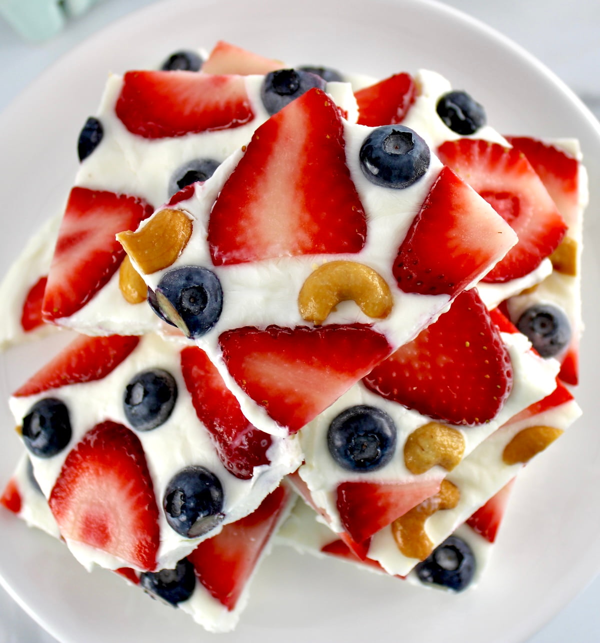 Frozen Yogurt Berry Bark stacked up on white plate