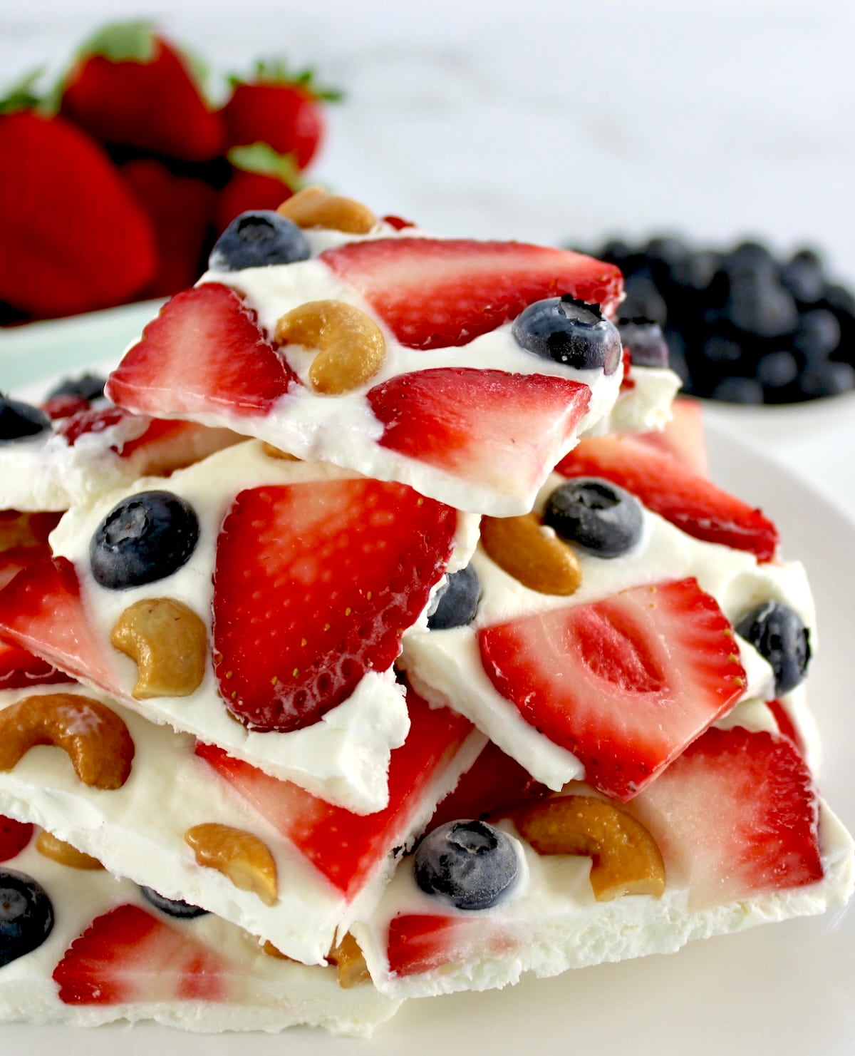 Frozen Yogurt Berry Bark cut into pieces stacked up on white platter