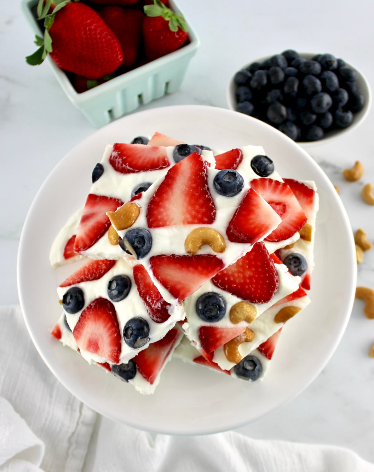 Frozen Yogurt Berry Bark stacked up on white plate