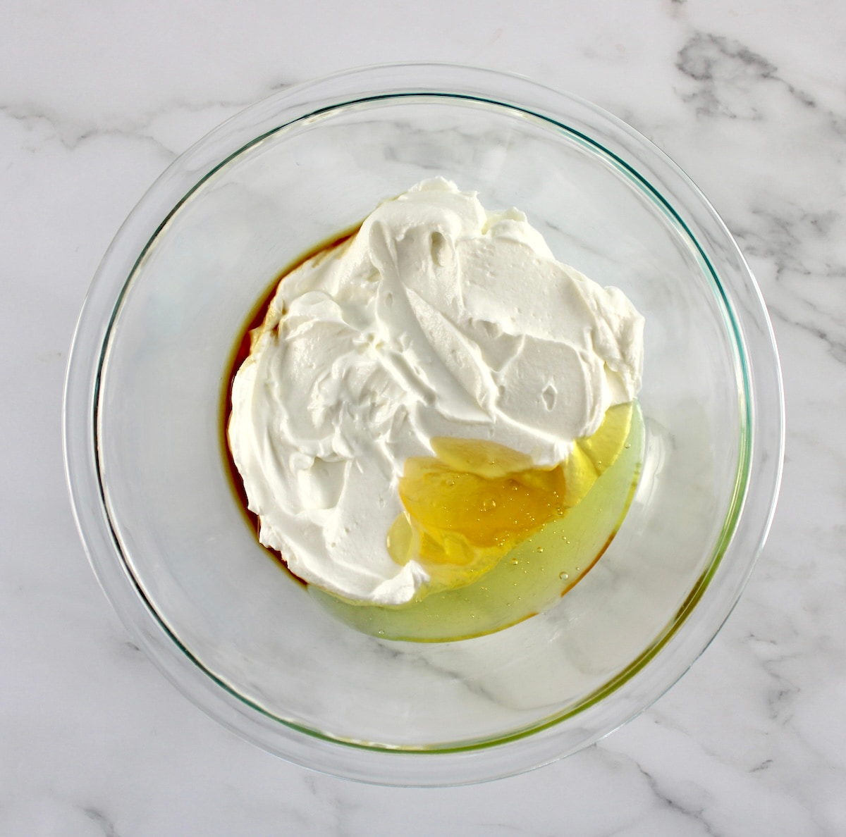 yogurt with vanilla and honey in glass bowl