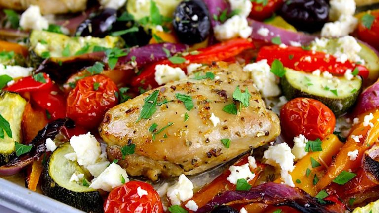 chicken and veggies on baking sheet with chopped parsley