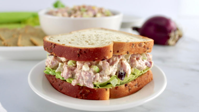 closeup of Ham Salad sandwich on white round plate