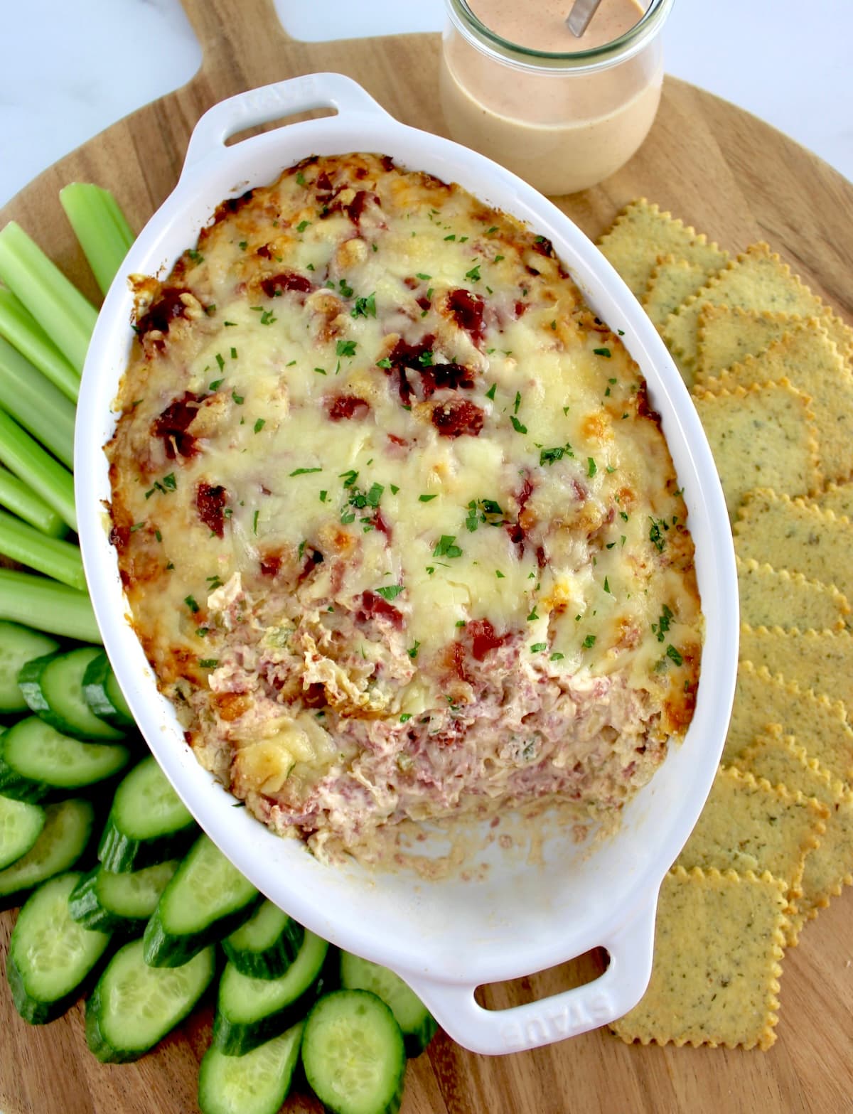 overhead view of Hot Reuben Dip in white oval casserole with some missing