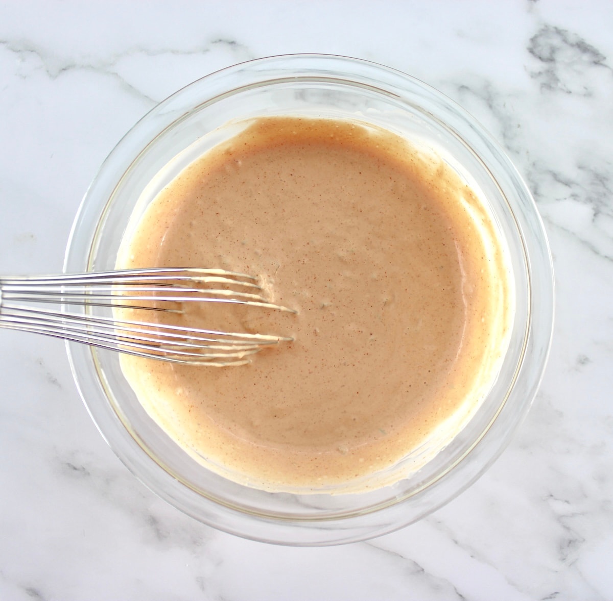 Keto Russian Dressing in glass bowl with whisk