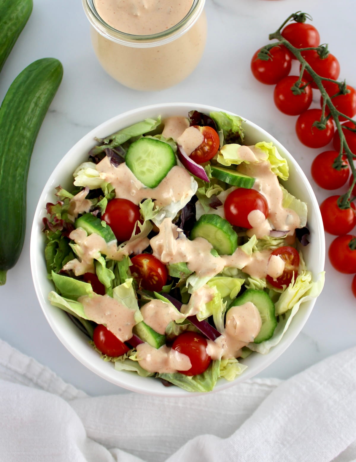 overhead view of salad with Keto Russian Dressing on top and in background in glass jar