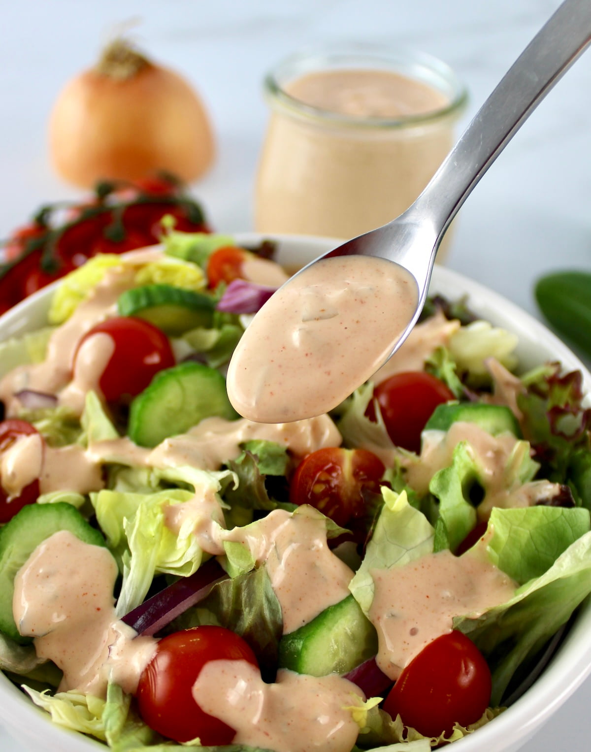 Keto Russian Dressing being spoon over salad