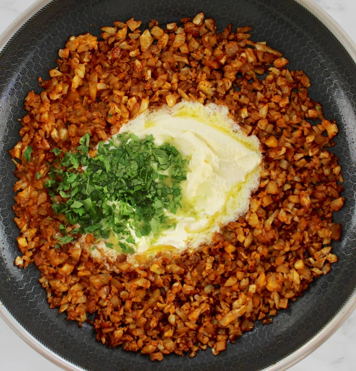 Stuffed Poblano Peppers stuffing ingredients in skillet with cilantro and mascarpone