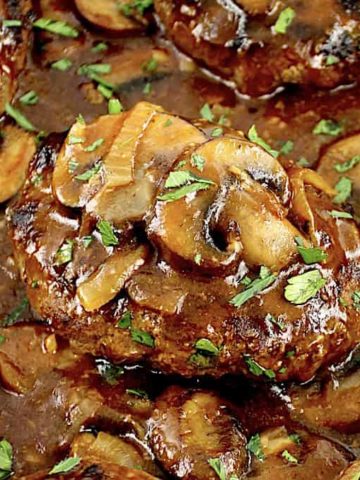 closeup of Salisbury Steak with mushroom gravy in skillet